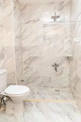 a bathroom with a toilet and a shower at Mirage Bay Resort Hurghada A-775 in Hurghada