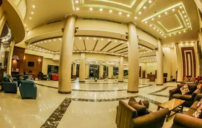 a lobby with couches and chairs in a building at Mirage Bay Resort Hurghada A-775 in Hurghada