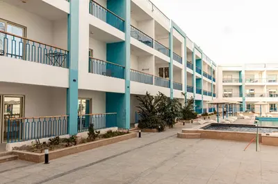 an apartment building with a pool and a courtyard at Mirage Bay Resort Hurghada A-775 in Hurghada