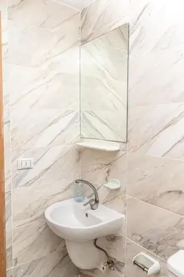 a white bathroom with a sink and a mirror at Mirage Bay Resort Hurghada A-775 in Hurghada