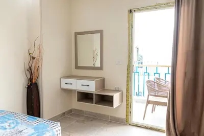 a bedroom with a mirror and a bed and a table at Mirage Bay Resort Hurghada C797 in Hurghada