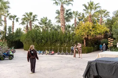 a woman standing in a courtyard with palm trees at Mirage Bay Resort Hurghada C797 in Hurghada
