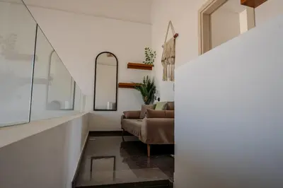 a living room with a couch and a mirror at Signature Kamaran duplex 1 bed pool & views in Hurghada