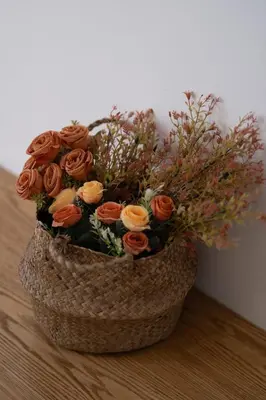 a bouquet of roses in a basket on a table at Signature Kamaran duplex 1 bed pool & views in Hurghada