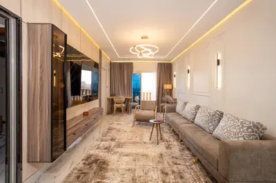 a living room with a couch and a television at Luxor Nile View Apartment Marah 1 in Luxor