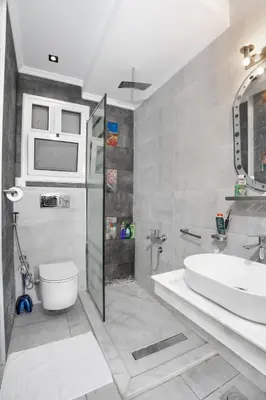 a bathroom with a sink and a toilet and a shower at Luxor Nile View Apartment Marah 1 in Luxor