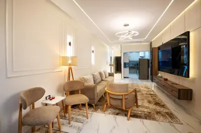 a living room with a couch and chairs and a tv at Luxor Nile View Apartment Marah 1 in Luxor