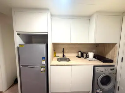 a small kitchen with a sink and a refrigerator at Pool front Mesca Cabana Minutes to Sandy Beach in Soma bay in Hurghada