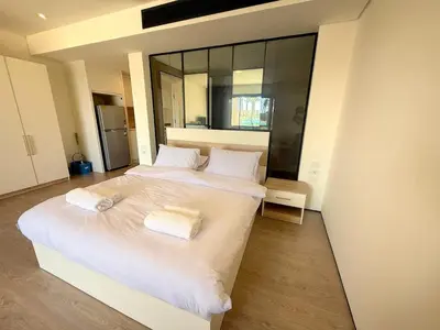a bedroom with two beds with white sheets and mirrors at Pool front Mesca Cabana Minutes to Sandy Beach in Soma bay in Hurghada