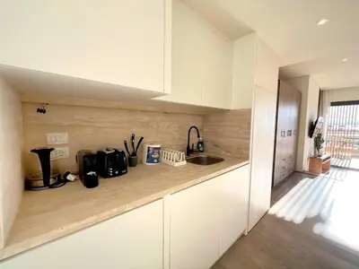 a kitchen with white cabinets and a sink at Beachfront Cabana Steps to Sandy Beach And Pool in Soma bay in Hurghada