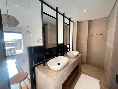 a bathroom with a sink and two mirrors at Beachfront Cabana Steps to Sandy Beach And Pool in Soma bay in Hurghada