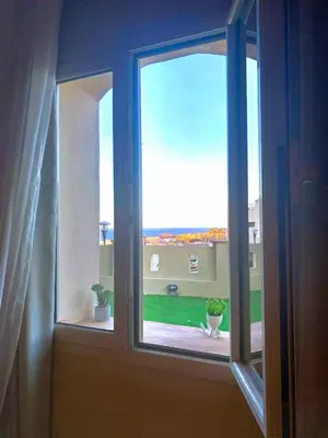 an open window with a view of a yard at Sahl hashesh Azzura apartment in Hurghada
