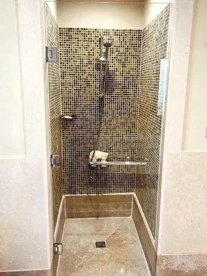 a shower with a glass door in a bathroom at Sahl hashesh Azzura apartment in Hurghada