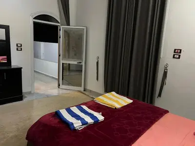 a bedroom with a bed with two towels on it at The Palace Guesthouse in Luxor
