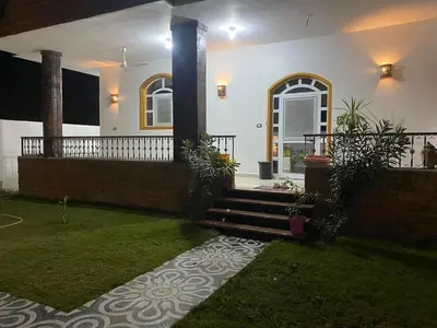 a house with a porch and stairs in a yard at The Palace Guesthouse in Luxor