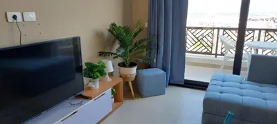 a living room with a flat screen tv and plants at 1 br stylish flat in phase 2 MH in Hurghada
