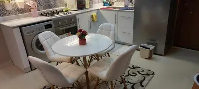 a kitchen with a table and chairs in a kitchen at 1 br stylish flat in phase 2 MH in Hurghada