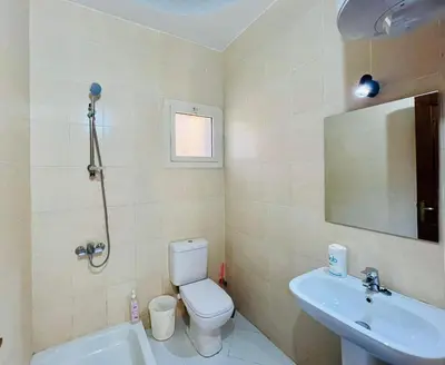 a bathroom with a toilet and a sink and a mirror at 2 bedroom flat with balcony in Hurghada