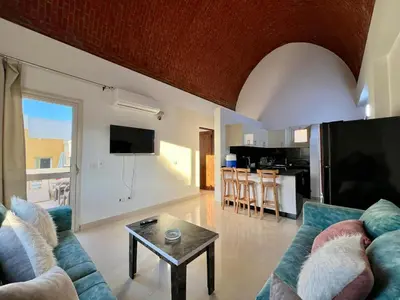 a living room with a couch and a table at 2 bedroom flat with balcony in Hurghada