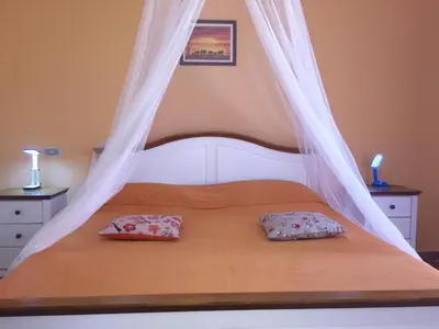 a bed with a canopy with two pillows on it at Iris Holiday Apartament in Hurghada