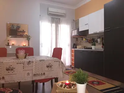 a kitchen with a table and a dining room at Iris Holiday Apartament in Hurghada