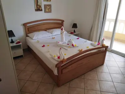 a bedroom with a bed with a cake on it at Iris Holiday Apartament in Hurghada