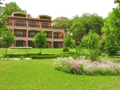 a large building with a garden in front of it at Pyramisa Island Hotel Aswan in Aswan