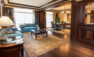 a living room with a blue couch and a table at Pyramisa Island Hotel Aswan in Aswan