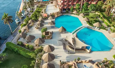 an aerial view of a resort with a pool and umbrellas at Pyramisa Hotel Luxor in Luxor
