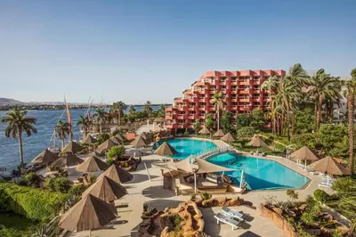 an aerial view of a resort with a swimming pool at Pyramisa Hotel Luxor in Luxor
