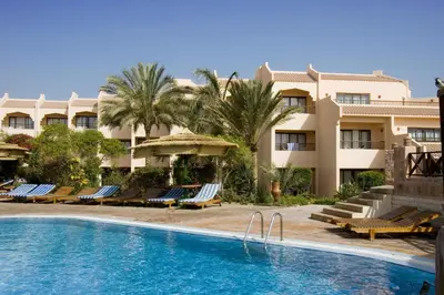 a hotel with a swimming pool in front of a building at Flamenco Beach & Resort Quseir in Quseir