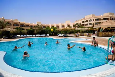 a group of people in a swimming pool at a resort at Flamenco Beach & Resort Quseir in Quseir