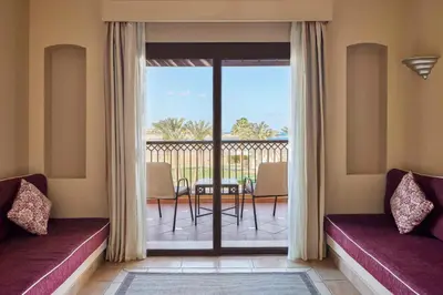 a room with two beds and a balcony with a view at JAZ Solaya in Coraya Bay