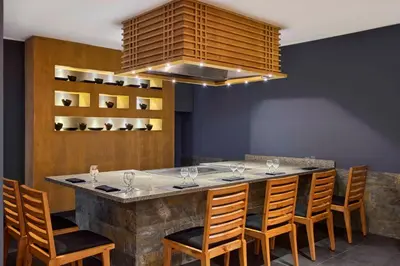 a bar with chairs and a large island in a restaurant at JAZ Solaya in Coraya Bay