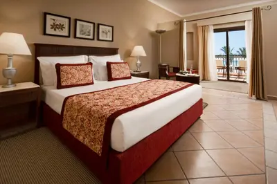 a bedroom with a large bed and a balcony at JAZ Solaya in Coraya Bay