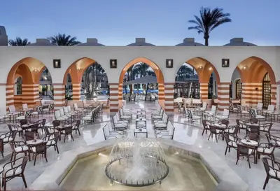 a large room with tables and chairs and a courtyard at Iberotel Makadi Beach in Hurghada