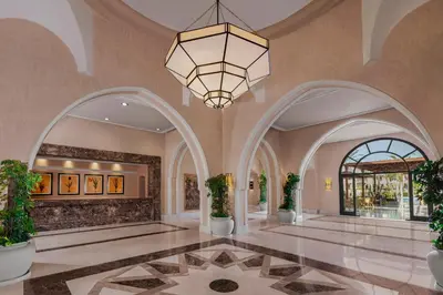 a lobby with arches and a chandelier at JAZ Makadi Star & Spa in Hurghada