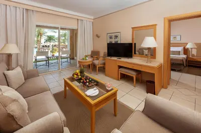 a living room with a couch and a desk at JAZ Makadi Star & Spa in Hurghada