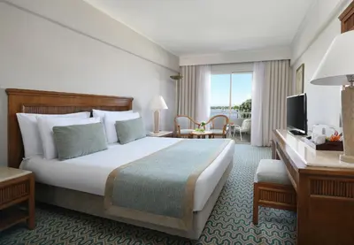 a hotel room with a large bed and a television at Iberotel Luxor in Luxor