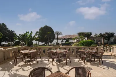 a row of tables and chairs on a patio at Iberotel Luxor in Luxor
