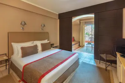 a hotel room with a bed and a television at JAZ Makadi Oasis Resort in Hurghada