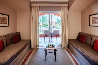 a living room with couches and a table at JAZ Makadi Oasis Resort in Hurghada