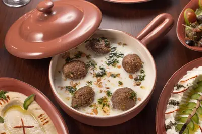 a table topped with a bowl of food with meatballs at Steigenberger Nile Palace Luxor - Convention Center in Luxor