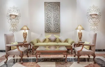 a living room with a couch and two chairs at Steigenberger Nile Palace Luxor - Convention Center in Luxor