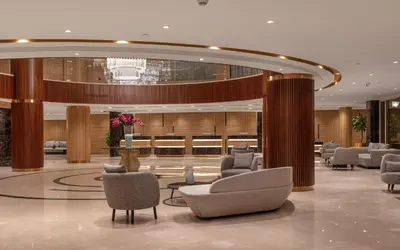 a lobby with couches and chairs in a building at Steigenberger Nile Palace Luxor - Convention Center in Luxor