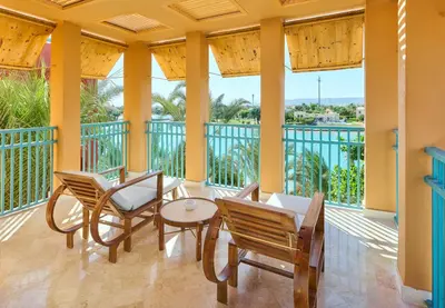 a porch with chairs and a table and somewindows at Sheraton Miramar Resort El Gouna in Hurghada