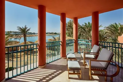 a balcony with chairs and a view of the water at Sheraton Miramar Resort El Gouna in Hurghada