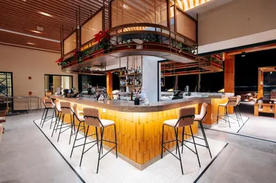a bar in a restaurant with stools at Sheraton Soma Bay Resort in Hurghada