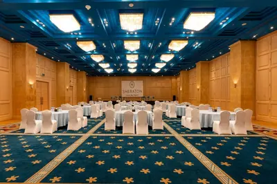 a banquet hall with white tables and white chairs at Sheraton Soma Bay Resort in Hurghada