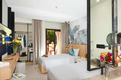 a hotel room with two beds and a mirror at Three Corners Rihana Resort El Gouna in Hurghada
